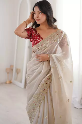 Beige tissue satin embroidered saree with unstitched blouse piece.