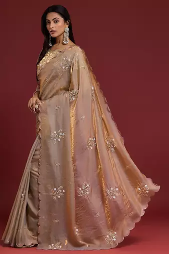 Beige tissue satin embellished saree with unstitched blouse piece.
