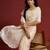 Cream tissue satin embellished saree with unstitched blouse piece.