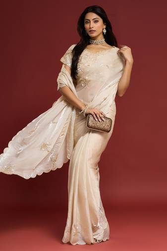 Cream tissue satin embellished saree with unstitched blouse piece.