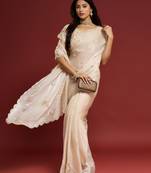 Cream tissue satin embellished saree with unstitched blouse piece.