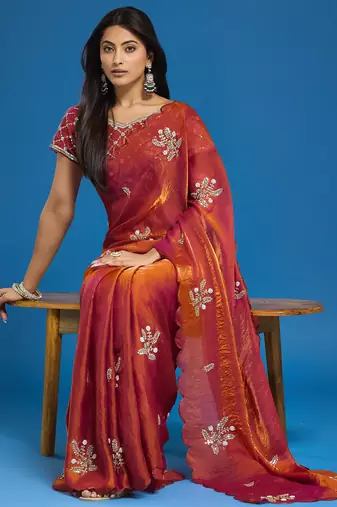 Orange tissue satin embellished saree with unstitched blouse piece.
