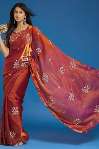 Orange tissue satin embellished saree with unstitched blouse piece.