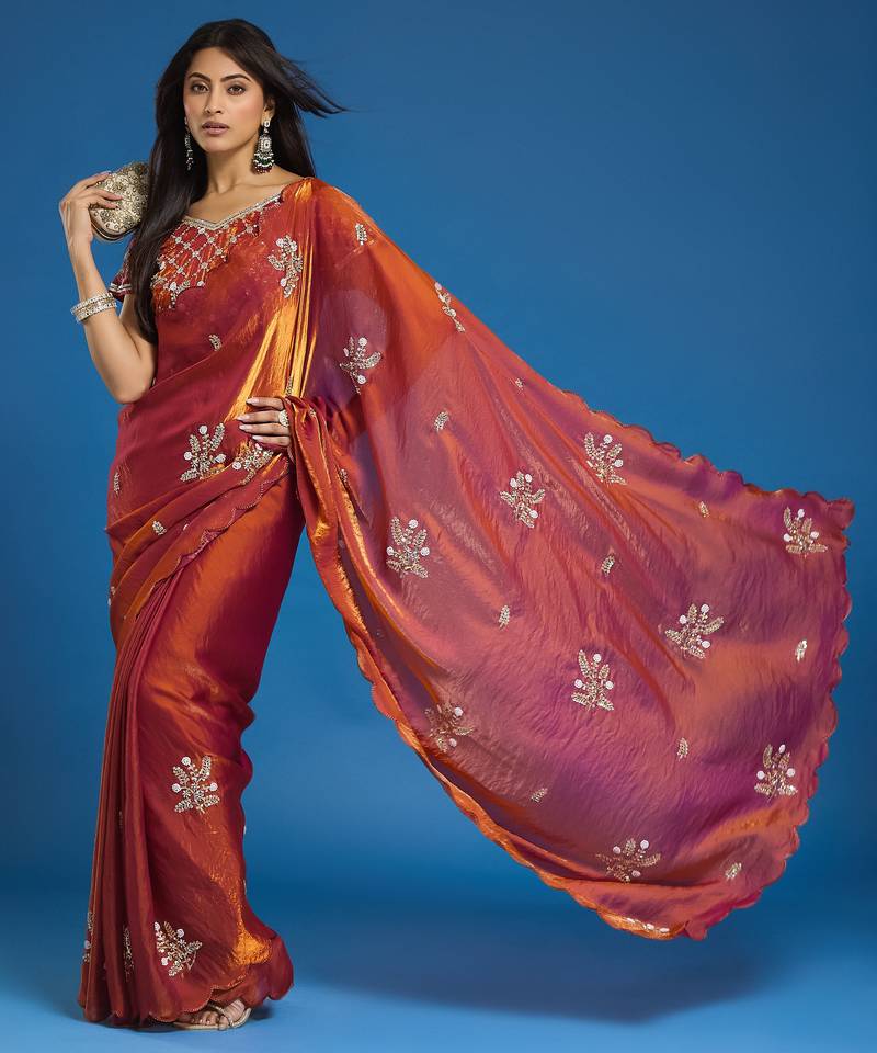 Orange tissue satin embellished saree with unstitched blouse piece.