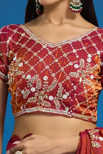 Orange tissue satin embellished saree with unstitched blouse piece.