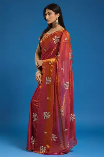 Orange tissue satin embellished saree with unstitched blouse piece.