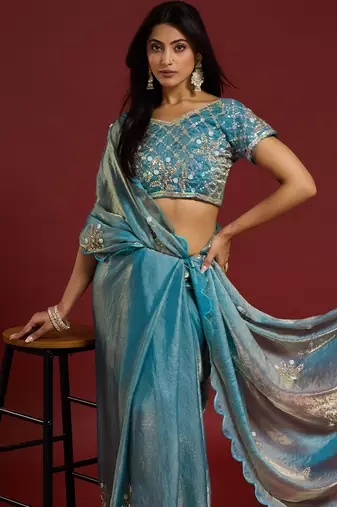 Sky blue tissue satin embellished saree with unstitched blouse piece.
