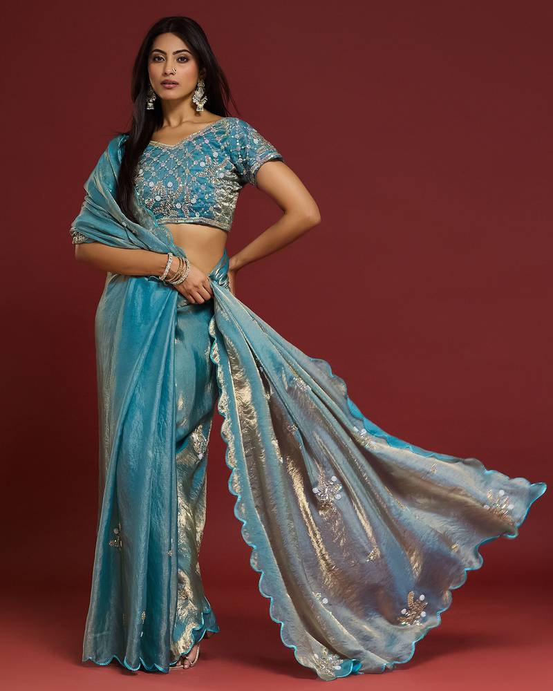 Sky blue tissue satin embellished saree with unstitched blouse piece.