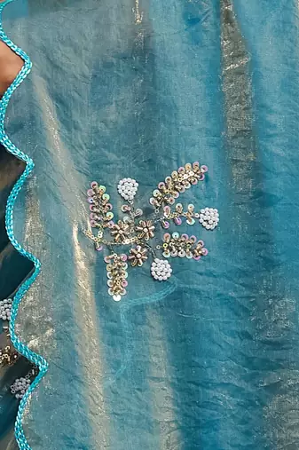 Sky blue tissue satin embellished saree with unstitched blouse piece.