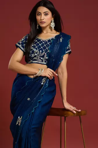 Teal tissue satin embellished saree with unstitched blouse piece.