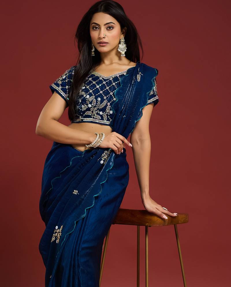 Teal tissue satin embellished saree with unstitched blouse piece.