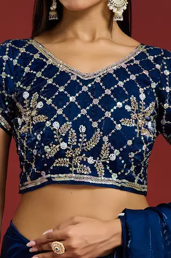 Teal tissue satin embellished saree with unstitched blouse piece.