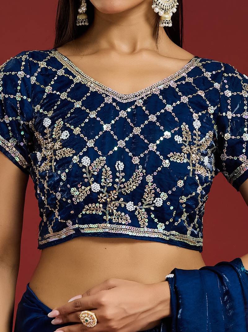 Teal tissue satin embellished saree with unstitched blouse piece.