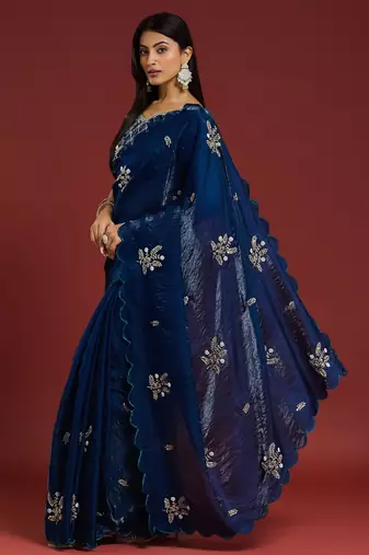 Teal tissue satin embellished saree with unstitched blouse piece.