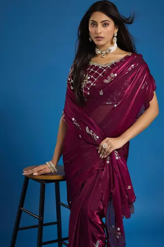 Wine tissue satin embellished saree with unstitched blouse piece.