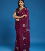 Wine tissue satin embellished saree with unstitched blouse piece.