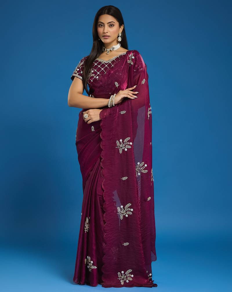 Wine tissue satin embellished saree with unstitched blouse piece.