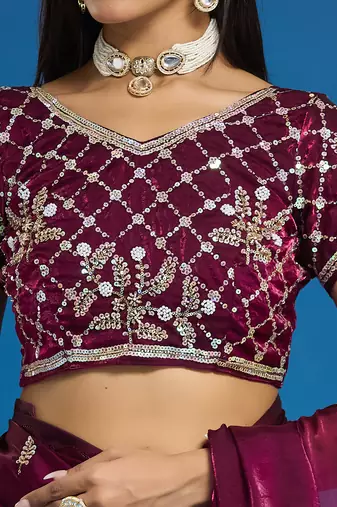 Wine tissue satin embellished saree with unstitched blouse piece.