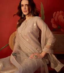 Beige silk blend woven design kurta set with dupatta.
