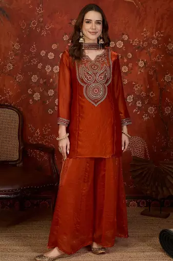 Rust tissue satin embroidered kurta sharara set.