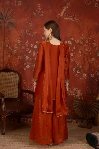 Rust tissue satin embroidered kurta sharara set.