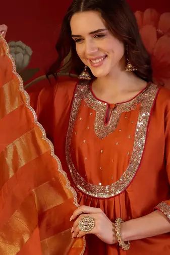 Orange cotton silk embroidered kurta set with dupatta.