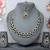 Beige color yellow gold plating festive wear designer necklace set