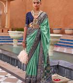Sea green sea green & gold-toned ethnic motifs zari silk blend banarasi saree