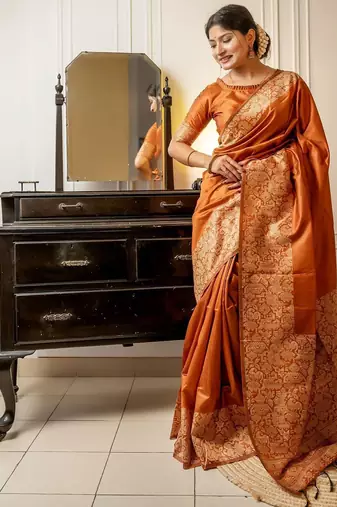 orange ethnic motif woven design tassel saree