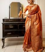 orange ethnic motif woven design tassel saree