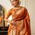 orange ethnic motif woven design tassel saree