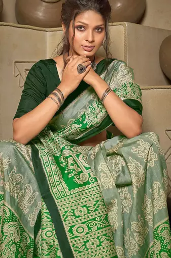 green green & cream-coloured ethnic motifs art silk ikat saree