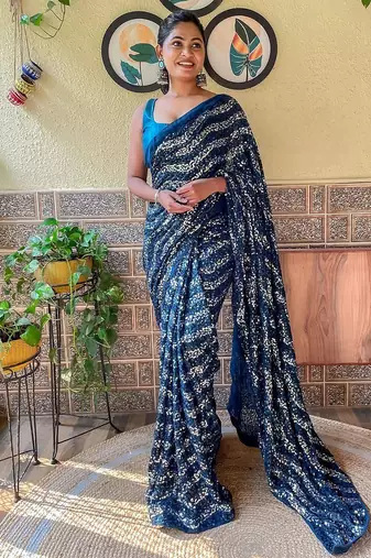 teal sequinned pure georgette saree
