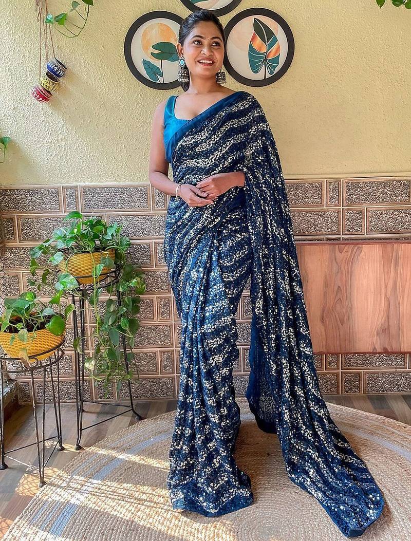 teal sequinned pure georgette saree