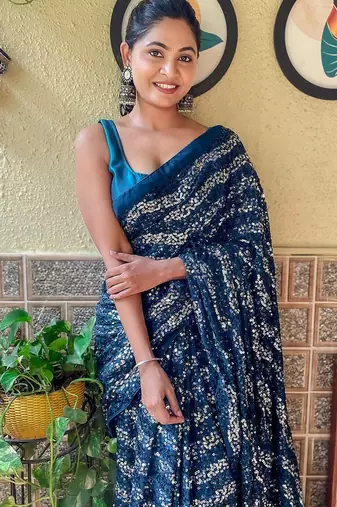teal sequinned pure georgette saree