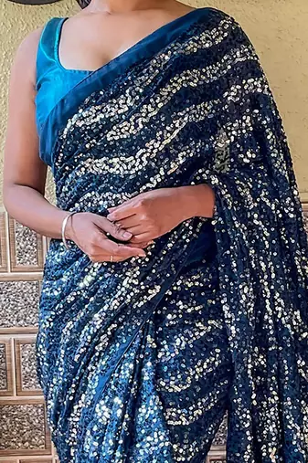 teal sequinned pure georgette saree