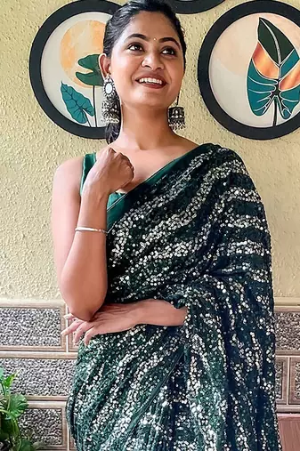 green sequinned poly georgette saree