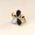 Gold-tone finish, glossy enamel petals, lightweight fit, flower design.