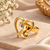 Dual heart design, polished finish, bold cocktail ring, romantic style.
