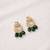 Gold plated green kundan earrings