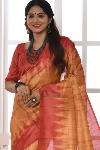 orange geometric printed tussar silk sarees with tassels