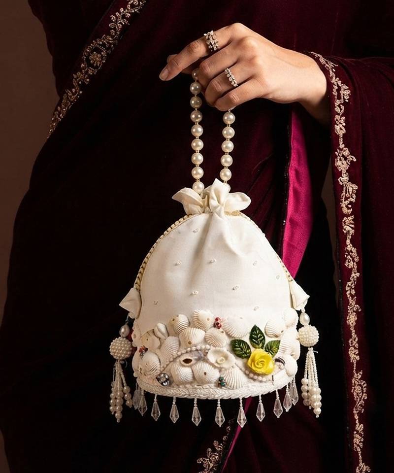 Ivory floral shell embellished potli bag