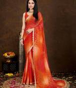 orange women bandhani printed embellished saree