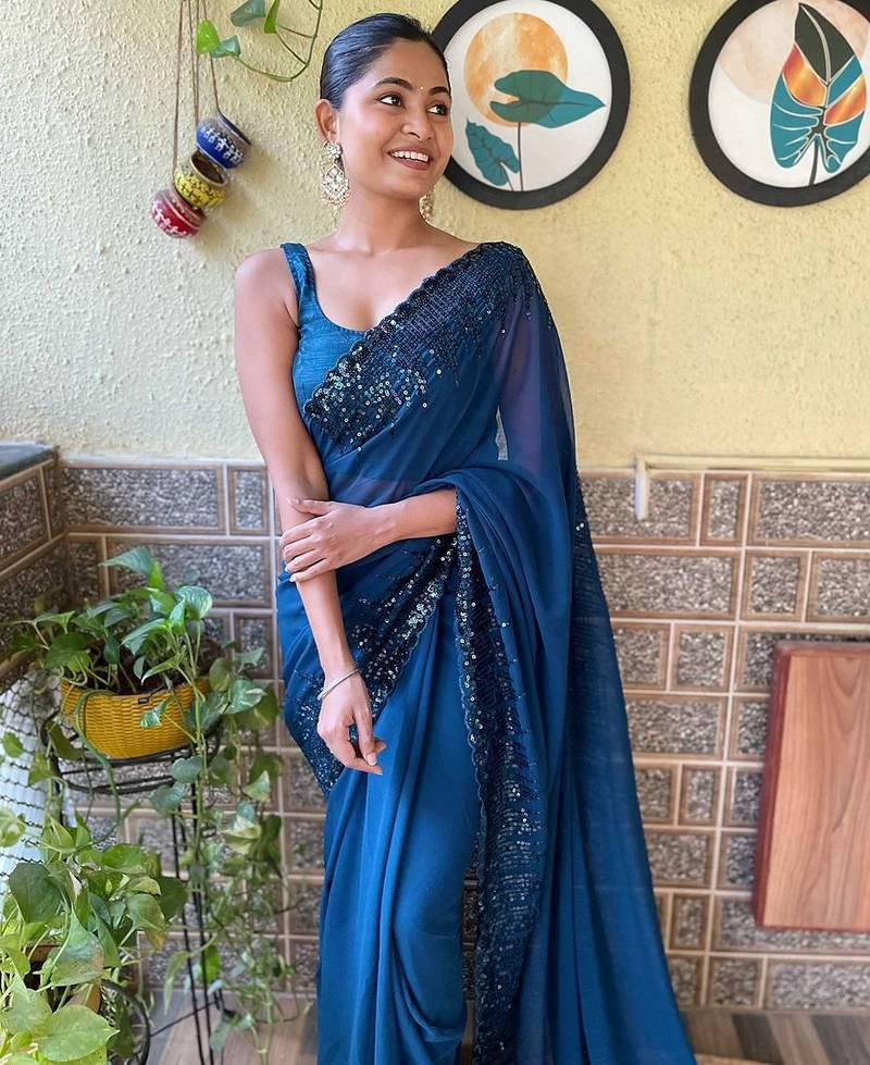 teal sequinned poly georgette saree with blouse piece