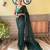 green sequinned poly georgette saree with blouse piece
