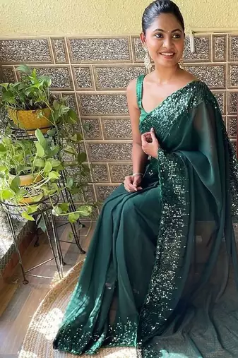 green sequinned poly georgette saree with blouse piece