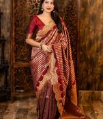 Maroon ethnic motifs woven design zari banarasi saree