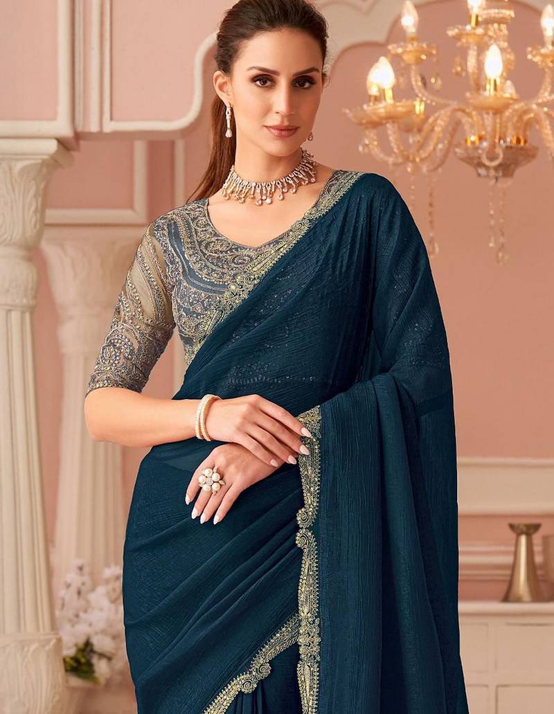 Teal sequinned pure georgette saree