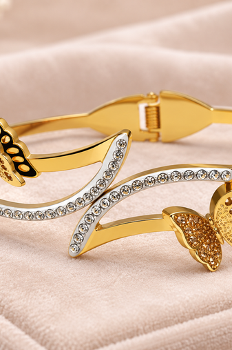 Gold-tone butterfly bangle bracelet with crystal embellishments