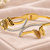 Gold-tone butterfly bangle bracelet with crystal embellishments